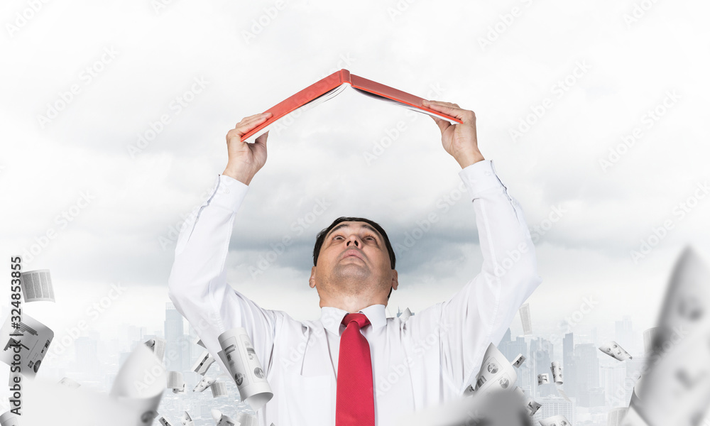 Senior businessman holding open book