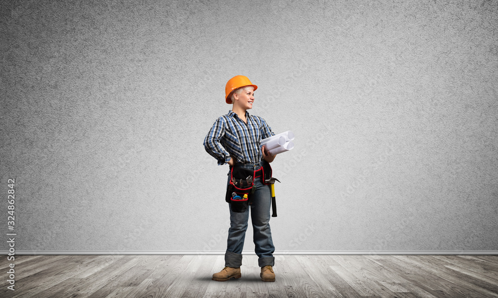 Attractive female architect in hardhat