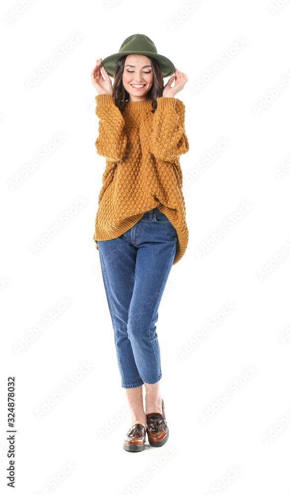 Beautiful young woman in warm sweater on white background