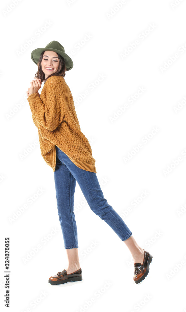 Beautiful young woman in warm sweater on white background