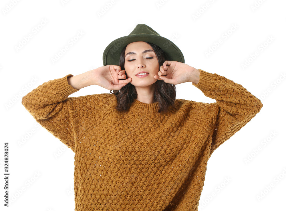 Beautiful young woman in warm sweater on white background