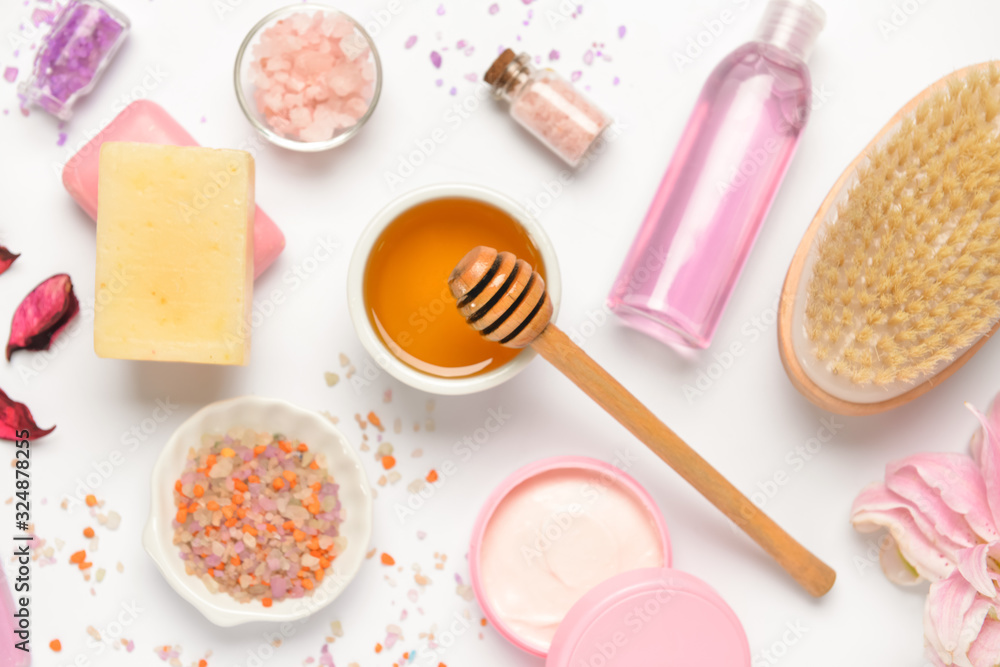 Composition with spa items and honey on white background