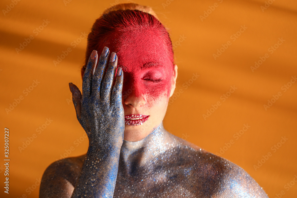 Beautiful woman with unusual makeup on color background