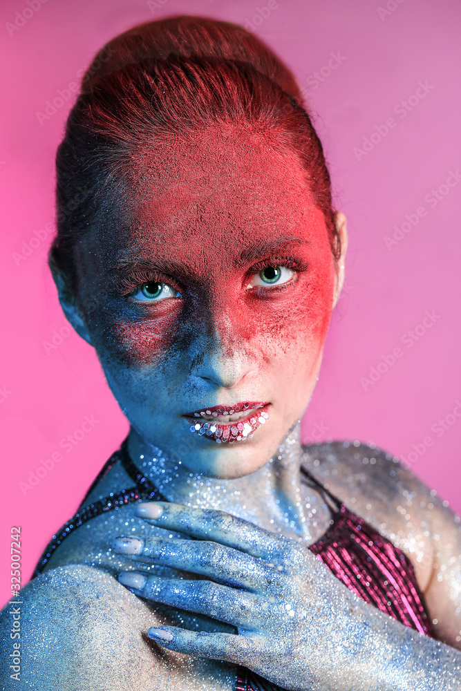 Beautiful woman with unusual makeup on color background