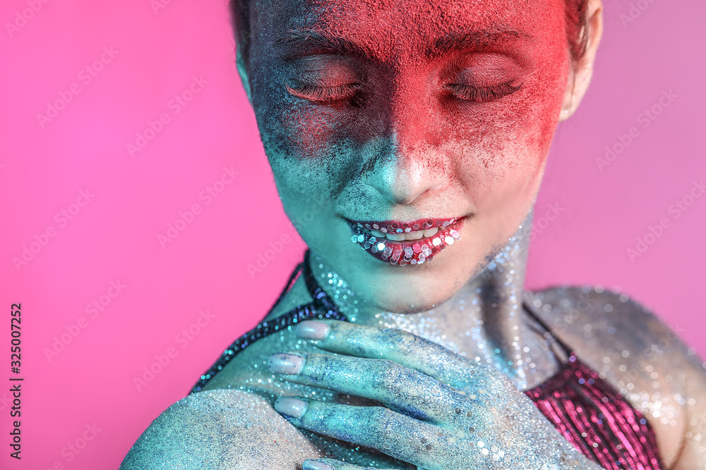 Beautiful woman with unusual makeup on color background