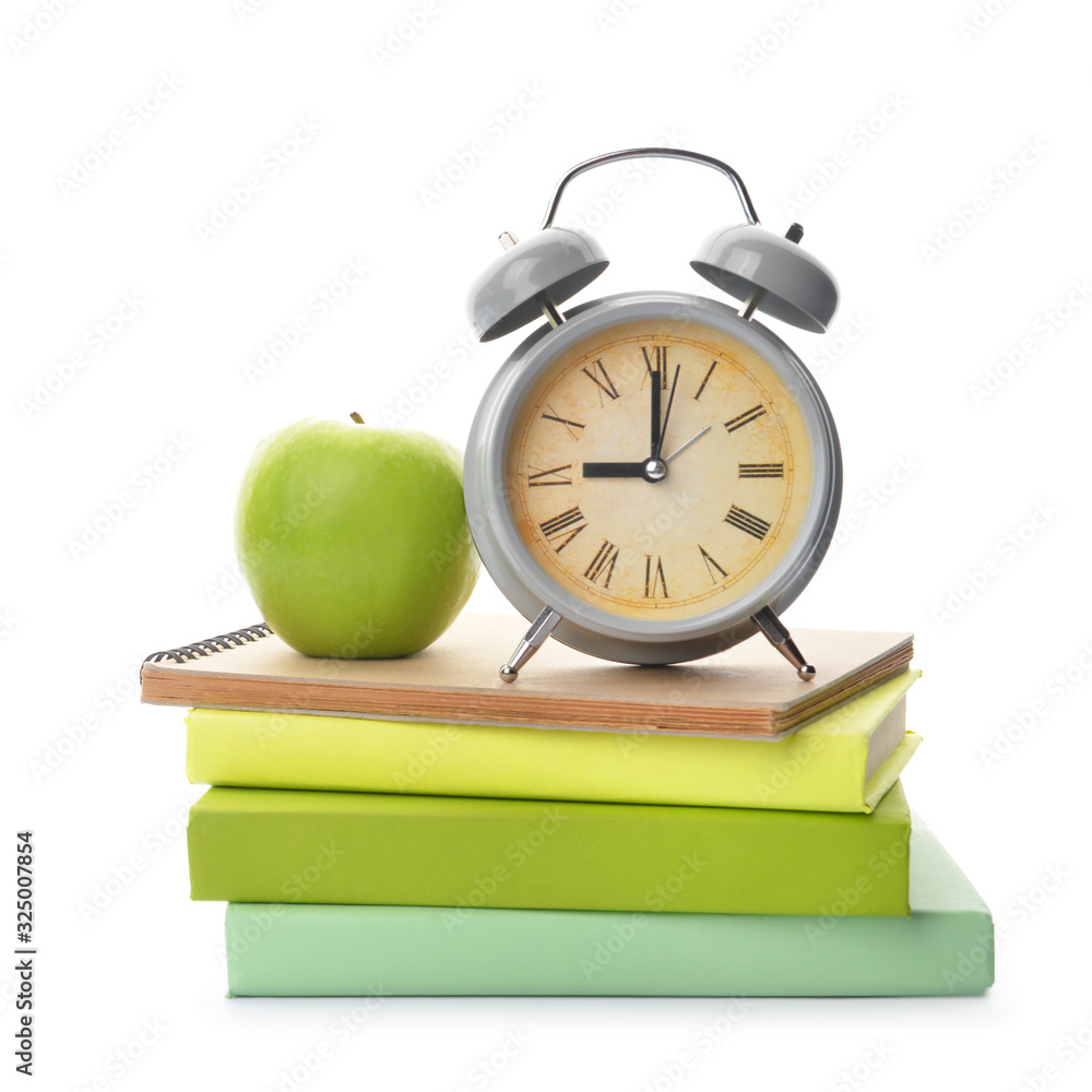 School books, apple and clock on white background. Time to study