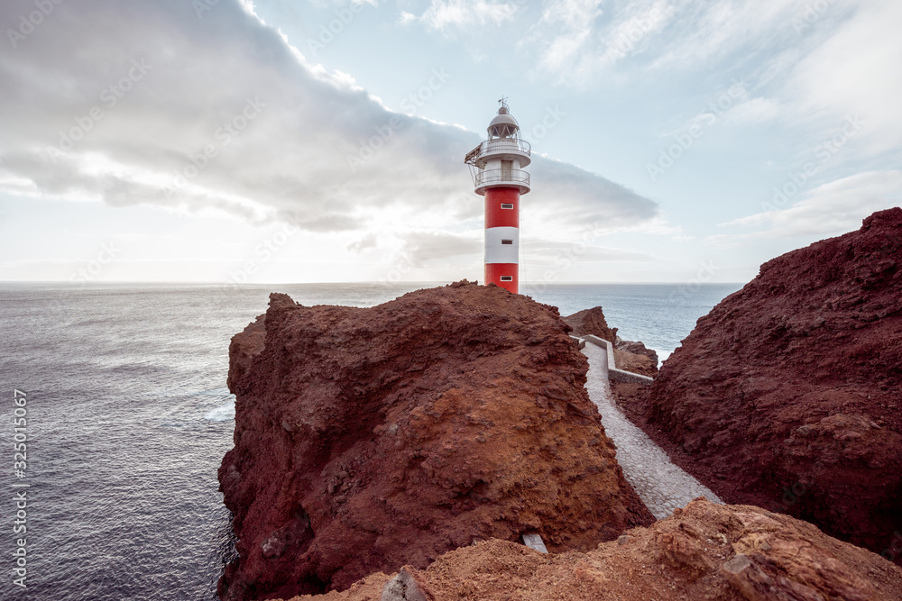 Beautiful landscape on a rocky ocean coast with lighthouse during a sunset. Teno cape on the north-w