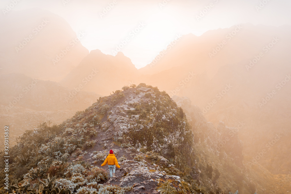 Breathtaking scenery on the mountain range under the clouds and ocean on the background during a sun