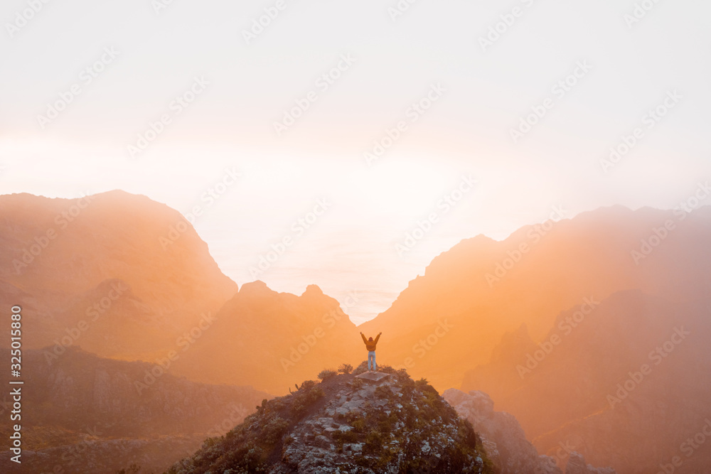 Breathtaking scenery on the mountain range under the clouds and ocean on the background during a sun