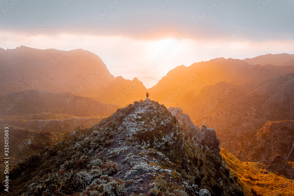 Breathtaking scenery on the mountain range under the clouds and ocean on the background during a sun