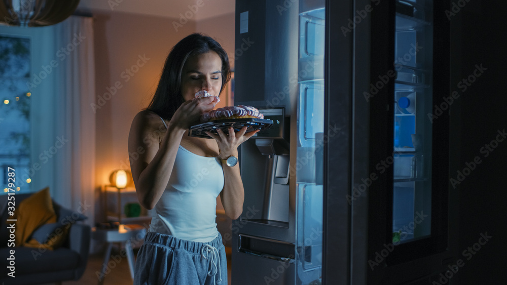 Hungry Beautiful Young Woman in the Kitchen in the Evening Opened the Fridge, Takes out a Piece of a