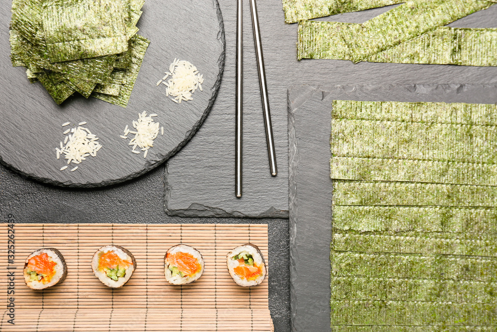 Composition with tasty seaweed sheets and sushi on table