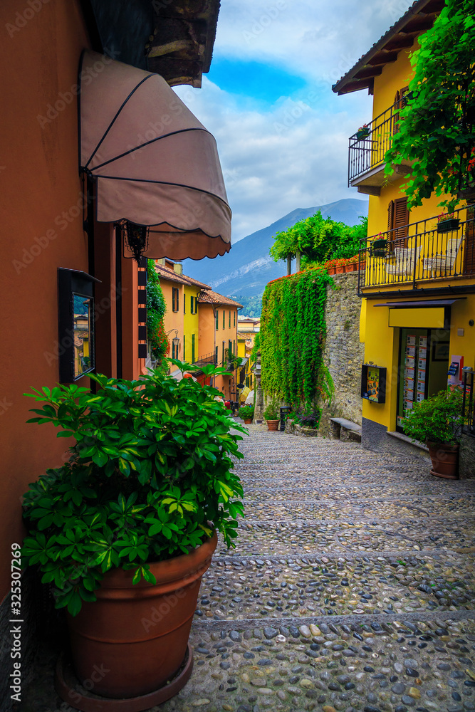 Cobblestone street view with colorful houses and shops, Bellagio, Italy