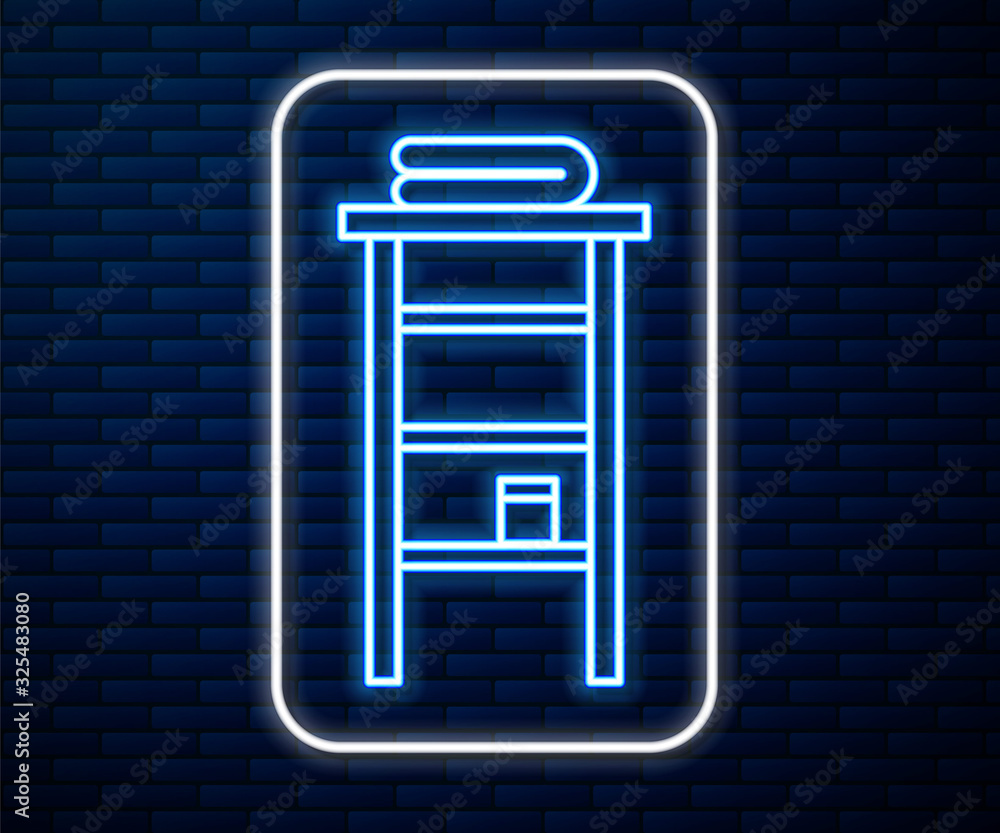 Glowing neon line Bathroom rack with shelves for towels icon isolated on brick wall background. Furn