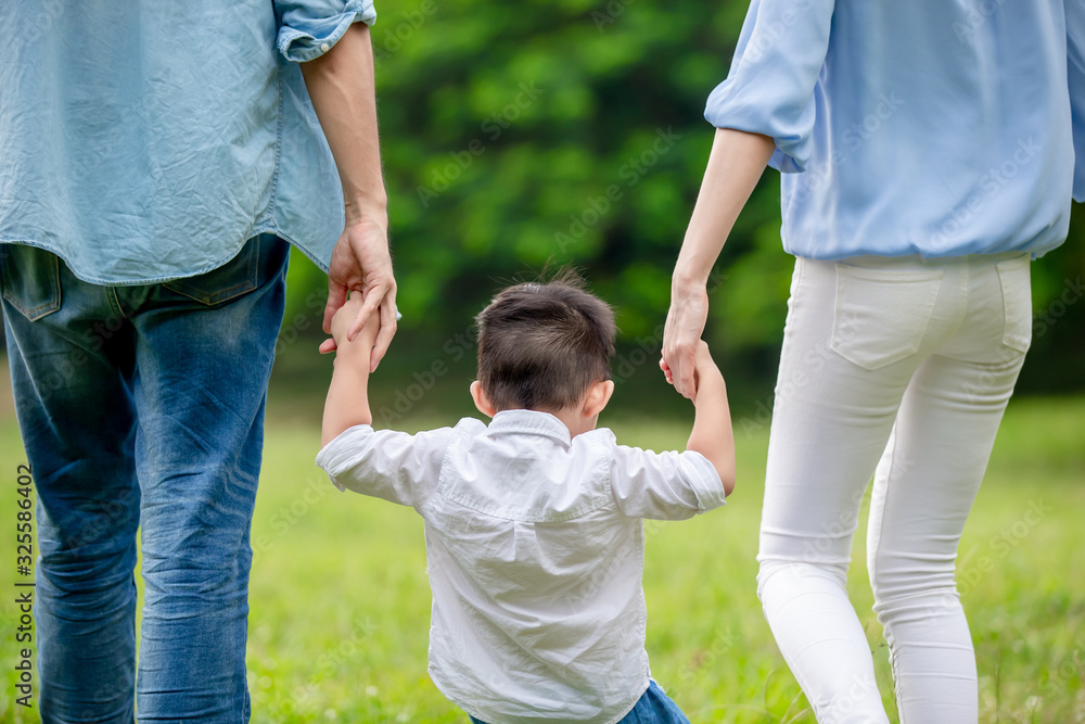 young parents walking with kid