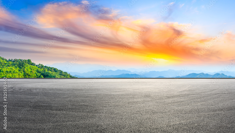 Empty race track and beautiful clouds with mountain at sunset,panoramic view.