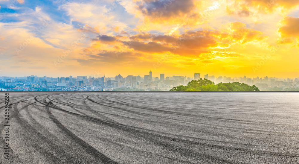 Empty race track and city skyline at sunrise in Hangzhou,China.