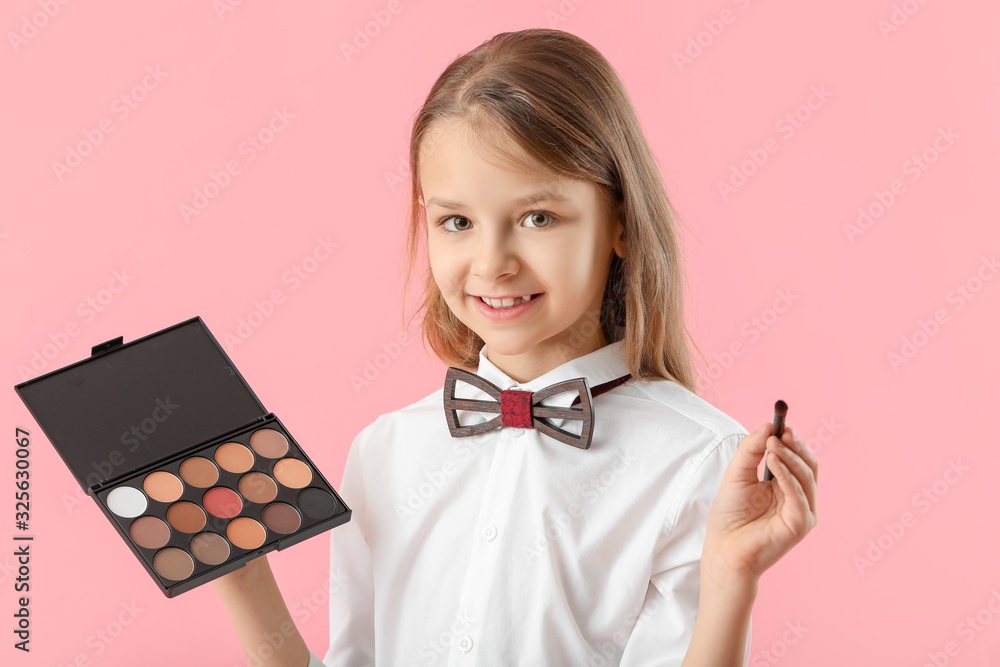 Cute little makeup artist on color background