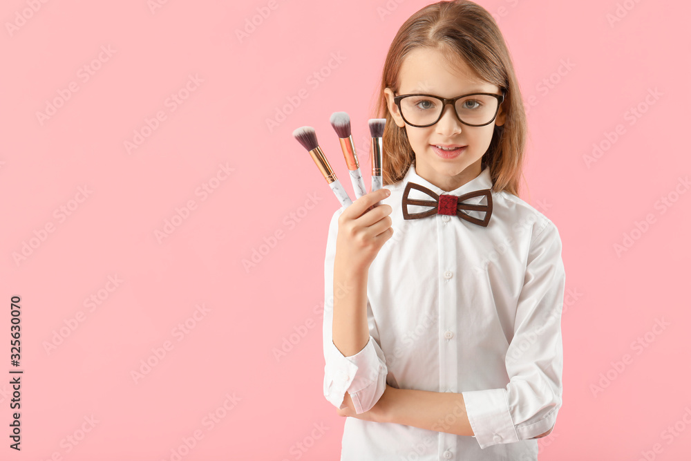 Cute little makeup artist on color background