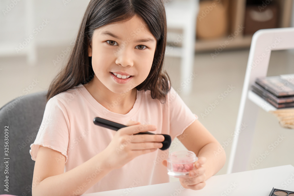 Cute little makeup artist at home