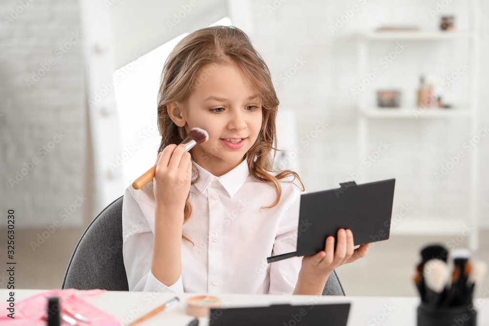 Cute little makeup artist at home