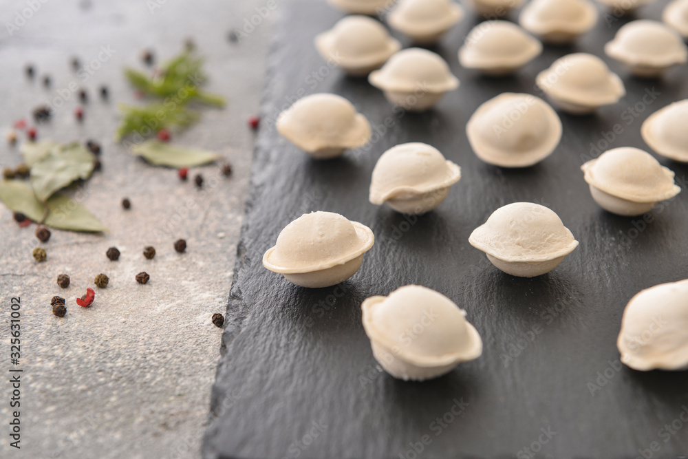 Raw fresh dumplings on slate plate, closeup