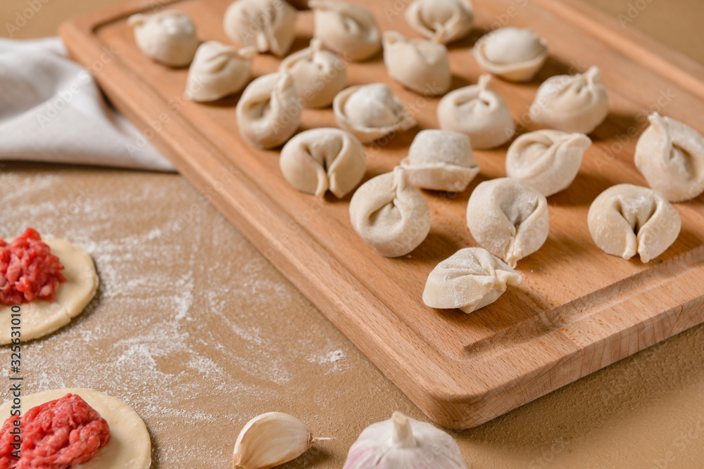 Making of tasty dumplings on color background