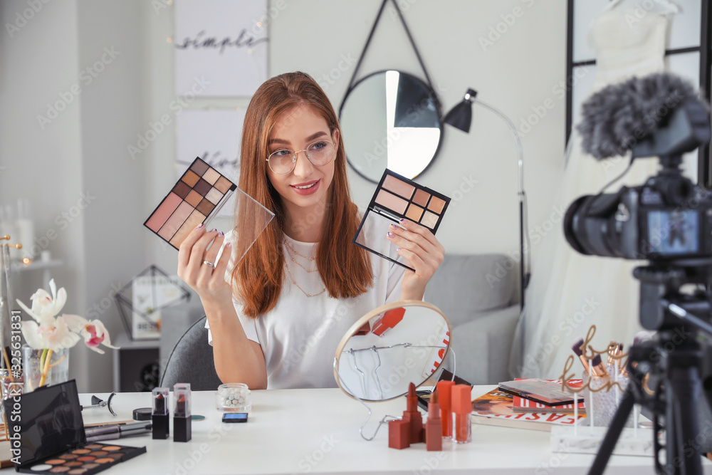 Young beauty blogger recording video at home