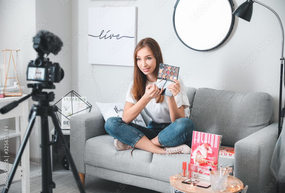 Young beauty blogger recording video at home