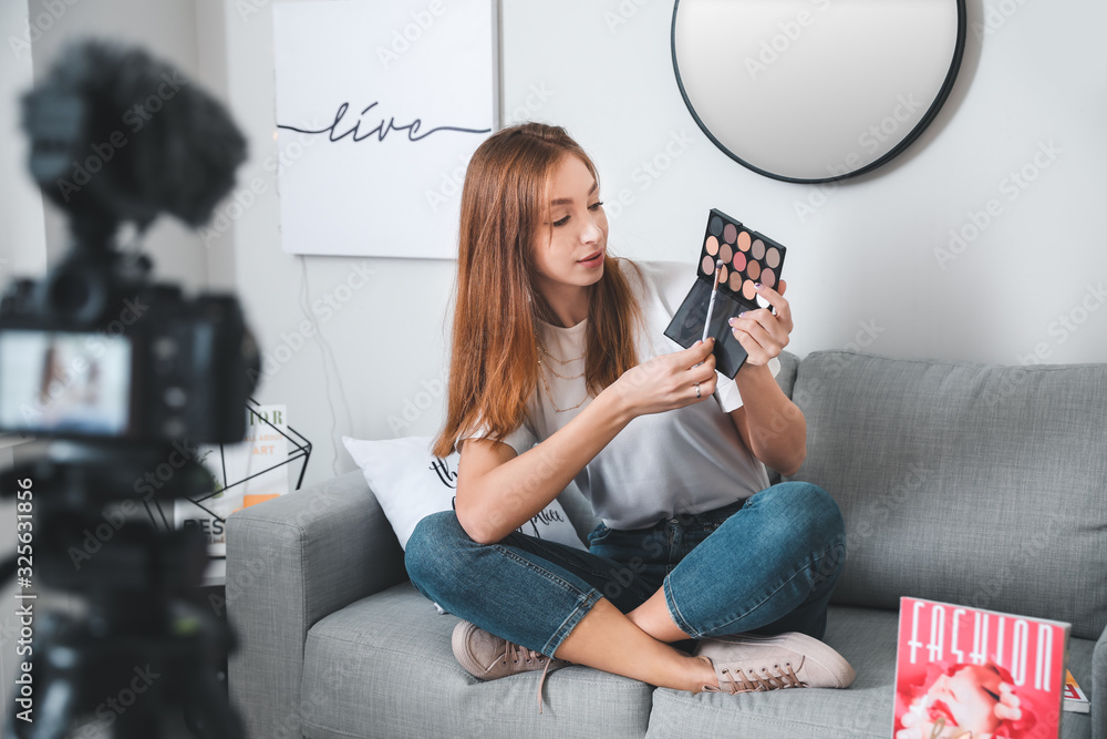 Young beauty blogger recording video at home