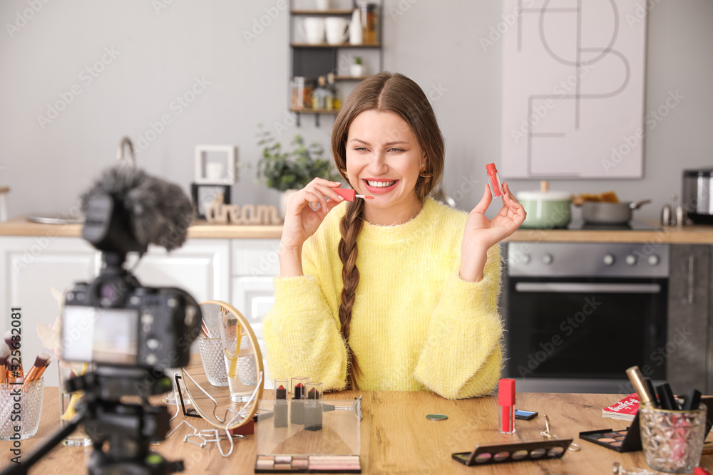 Young beauty blogger recording video at home