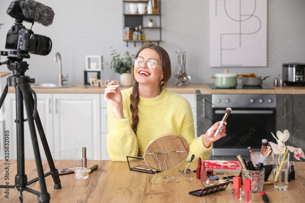 Young beauty blogger recording video at home