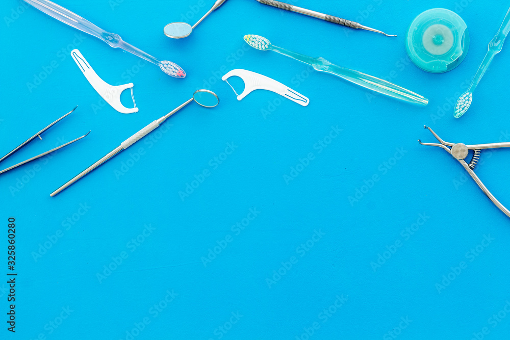 Dental care concept. Stomatological tools frame - with floss - on blue background top-down frame cop