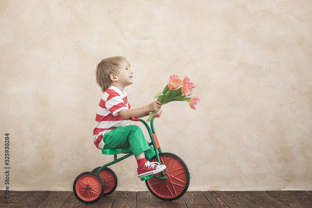 Funny child holding bouquet of flowers