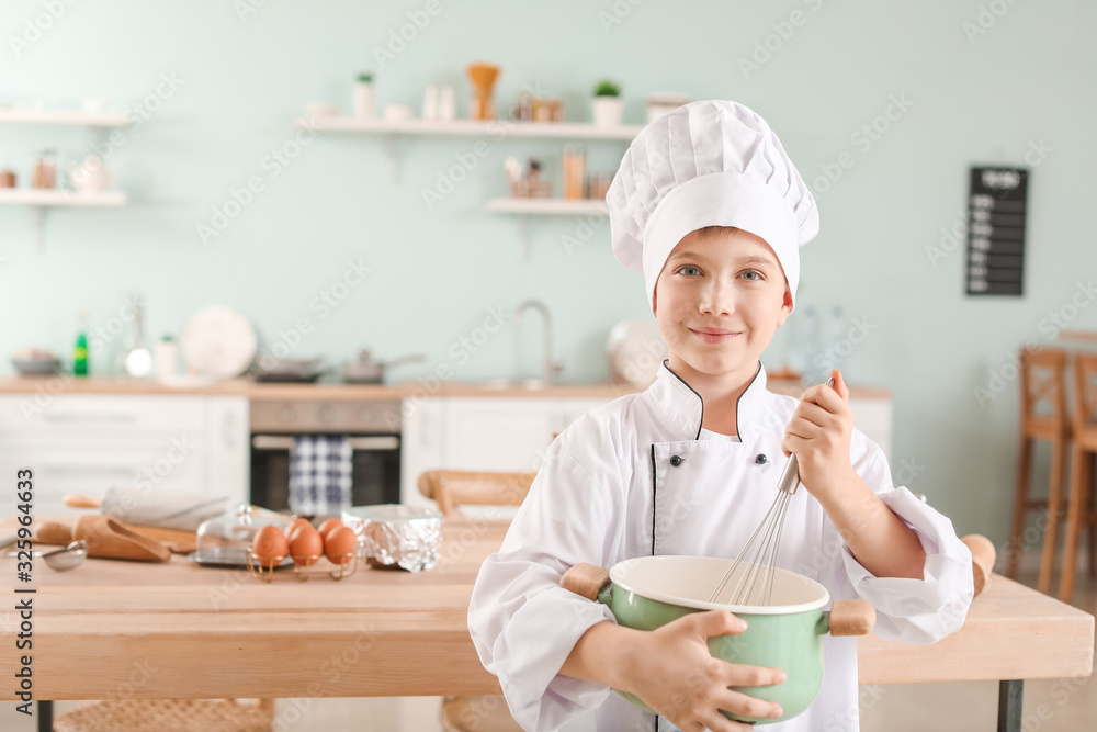 Cute little chef in kitchen