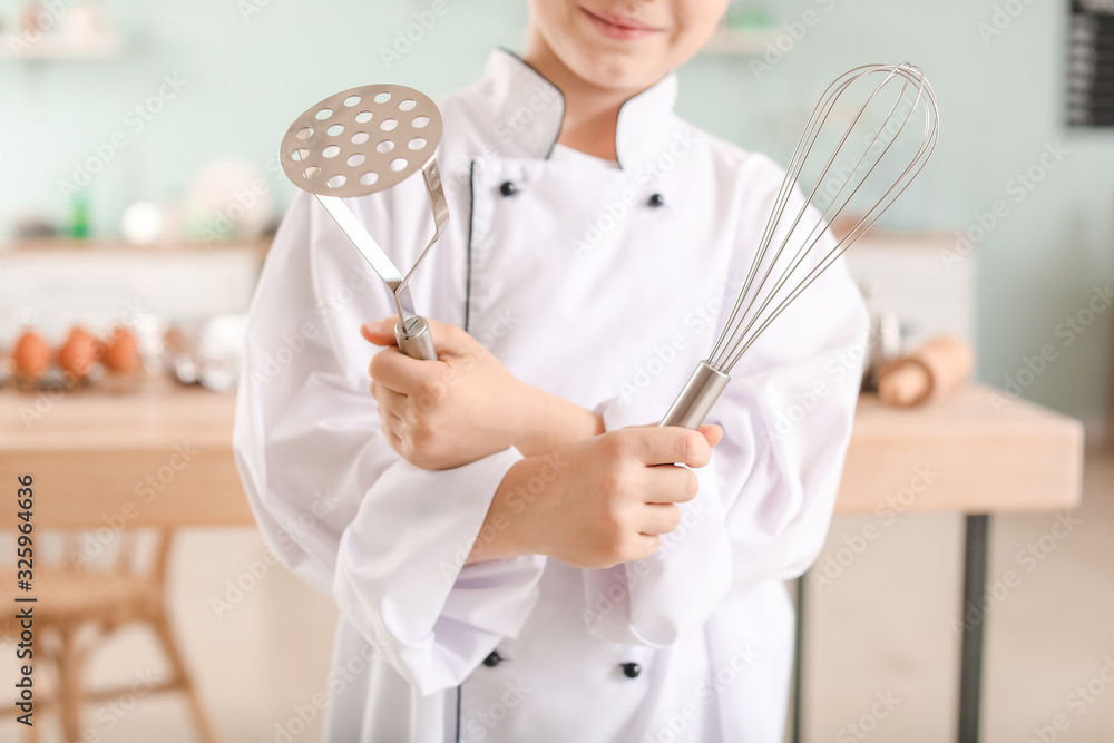 Cute little chef in kitchen