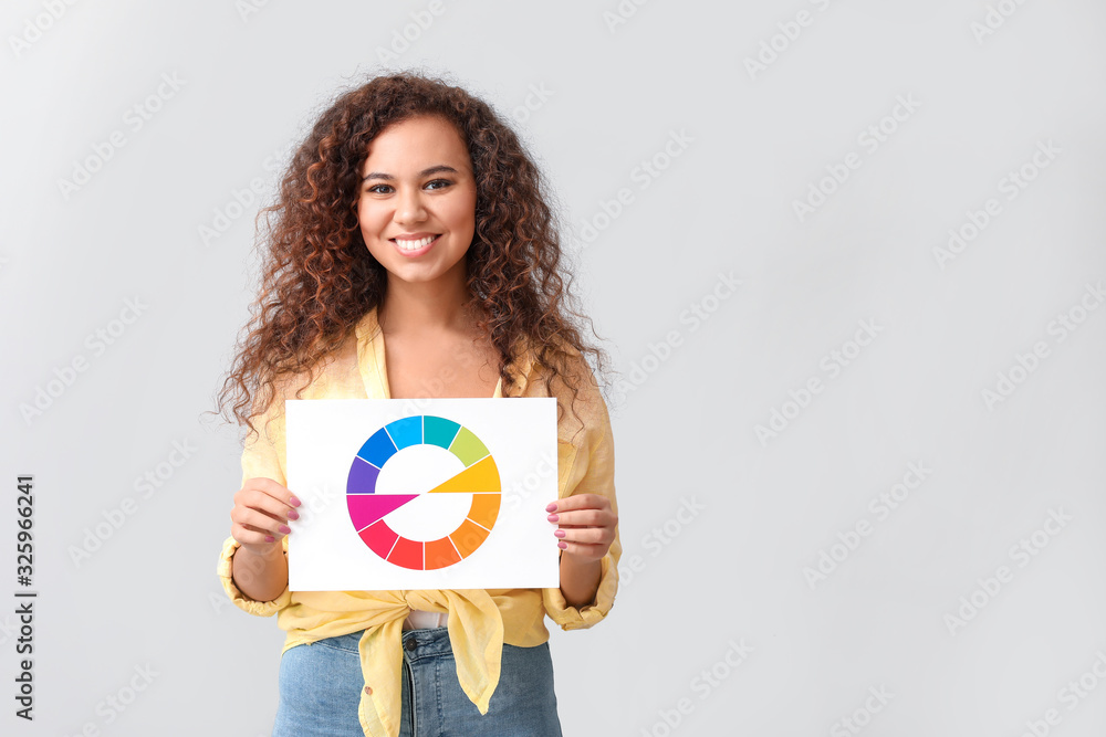 African-American woman with color palette on grey background