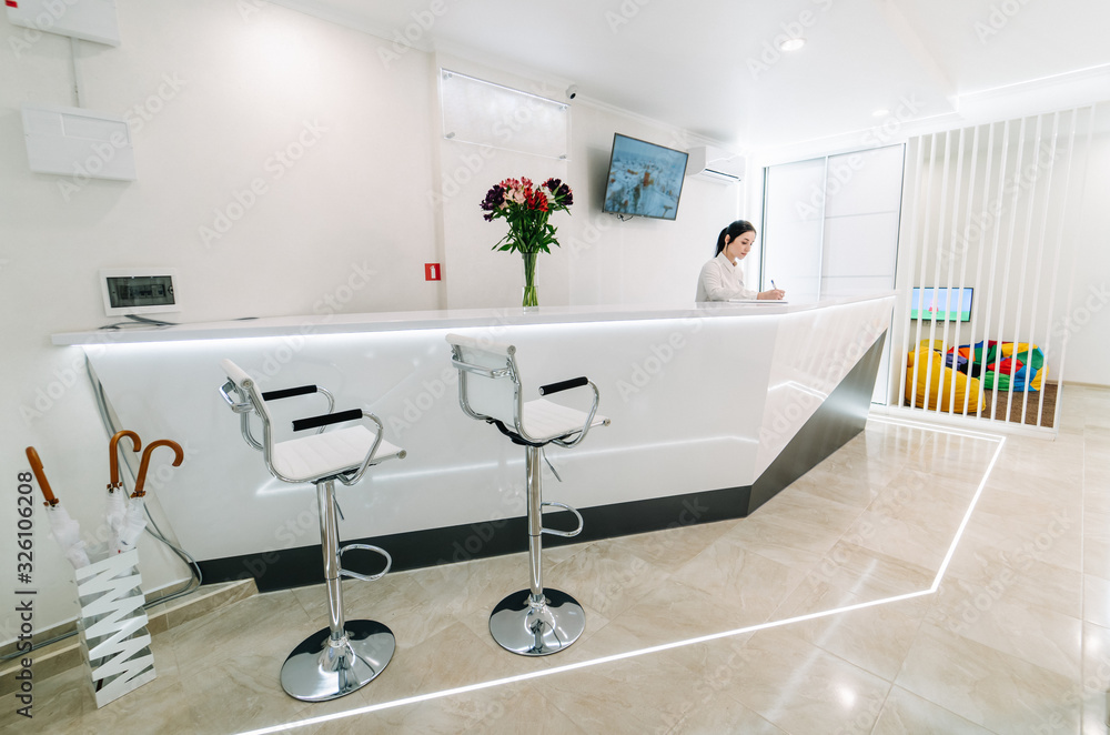 Reception area at the dental clinic. The workplace is a table with a computer.