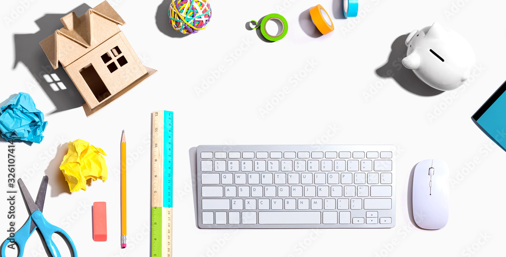 Office supplies with a computer keyboard and a cardboard house