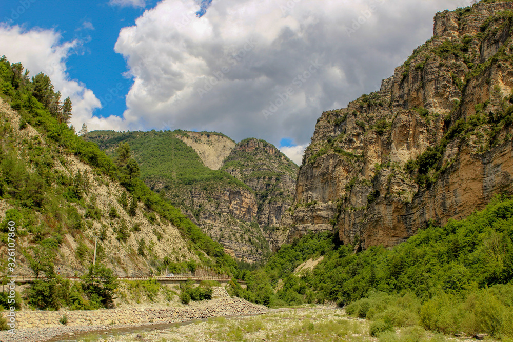 Beautiful summer mountain landscape in France, Alpine with road, car and mountain river