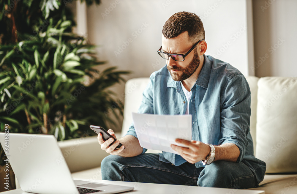 young   man freelancer working at home on a computer.