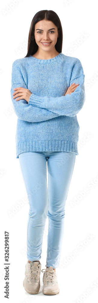 Beautiful young woman in warm sweater on white background