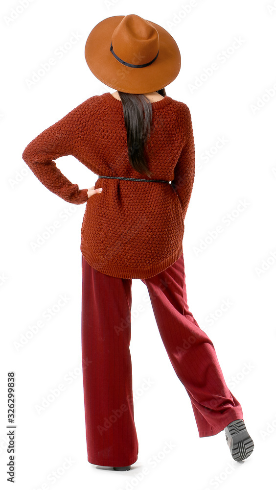 Beautiful young woman in warm sweater on white background, back view