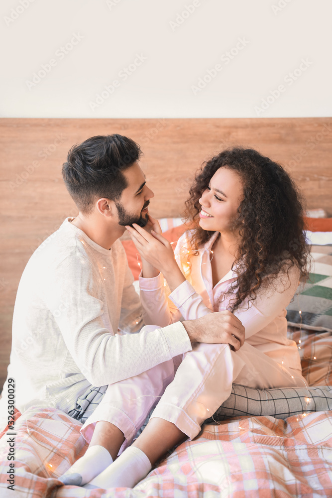 Happy young couple in bedroom