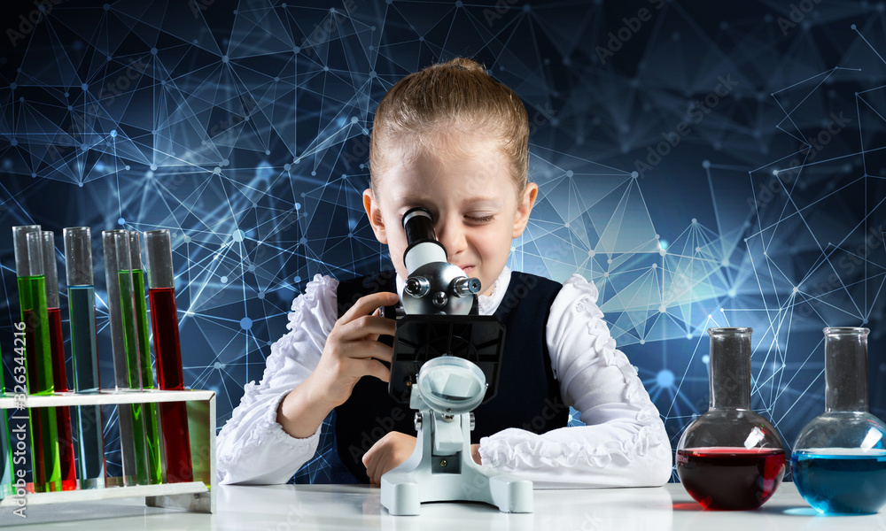 Little scientist looking through microscope