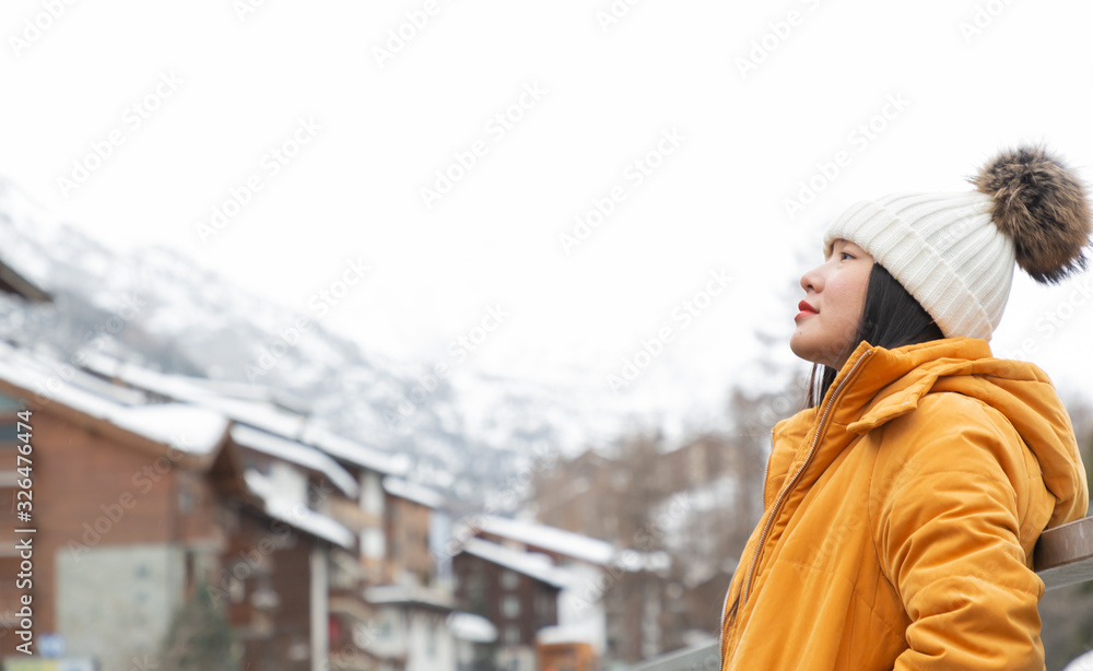 一名亚洲妇女和她的家人正在泽享受寒假，并进行家庭活动