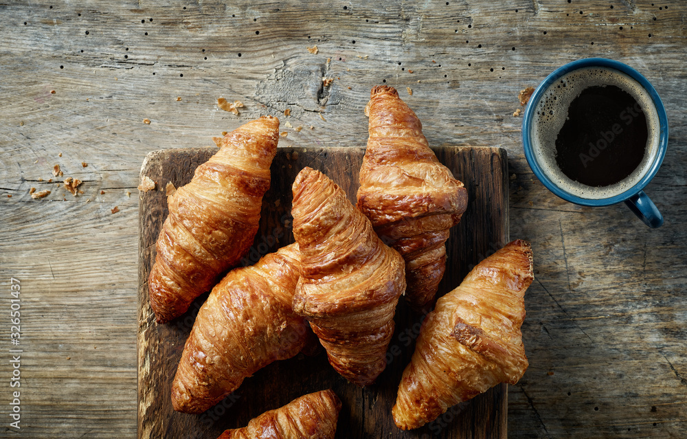 freshly baked croissants on wooden table