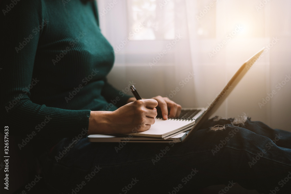 businessman hand working with new modern computer and writing on the notepad strategy diagram as con