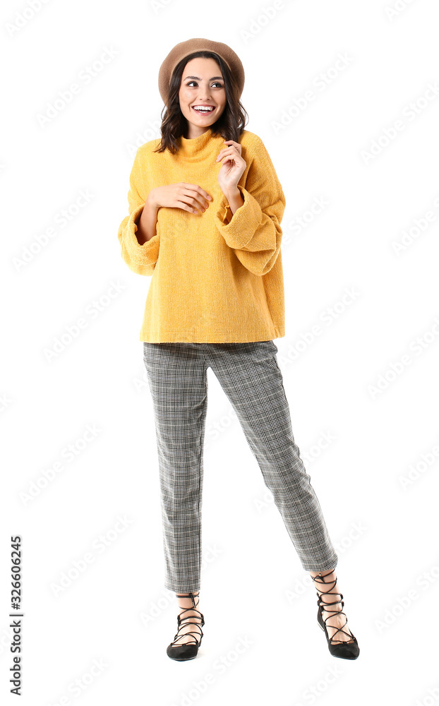 Beautiful young woman in warm sweater on white background