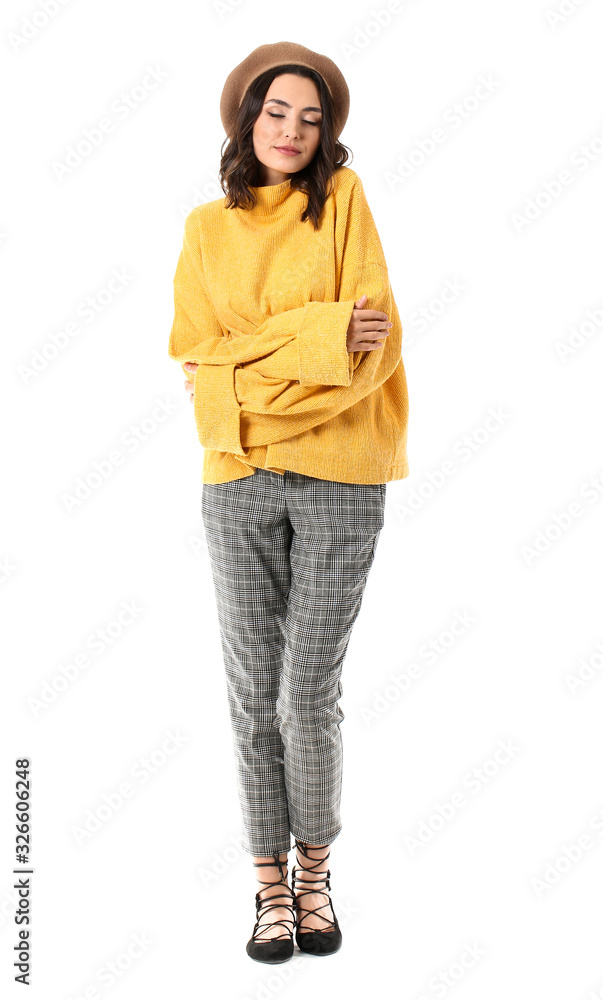 Beautiful young woman in warm sweater on white background